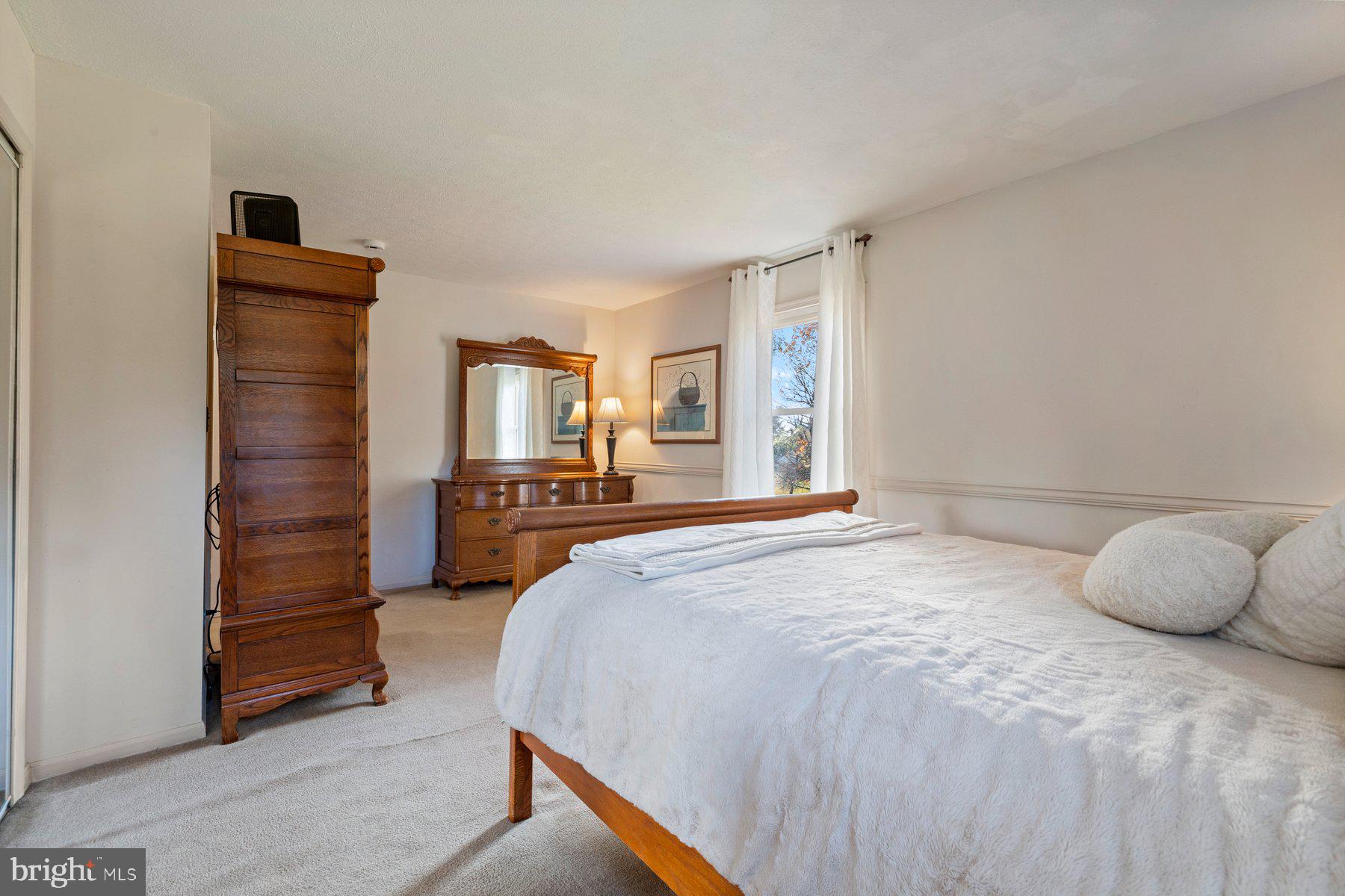 5130 Perry Road Mount Airy, MD 21771 - Photo 18 of 46 a spacious bedroom with a bed and a couch