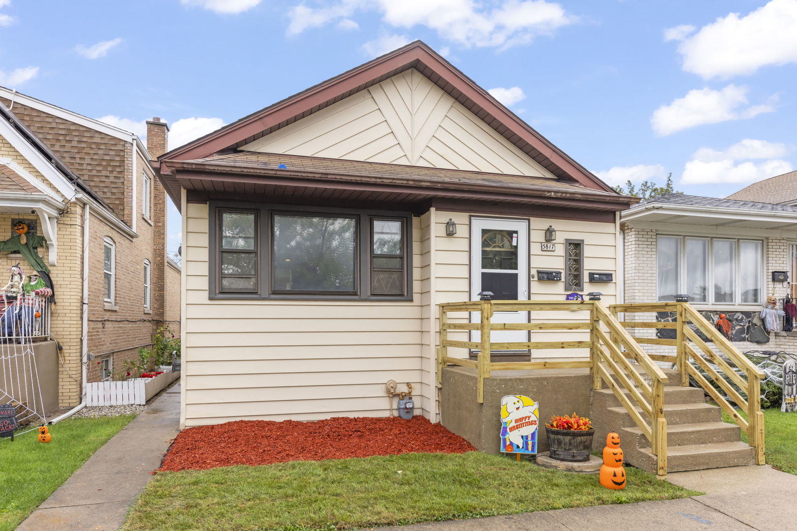 a view of a house with a patio and a yard
