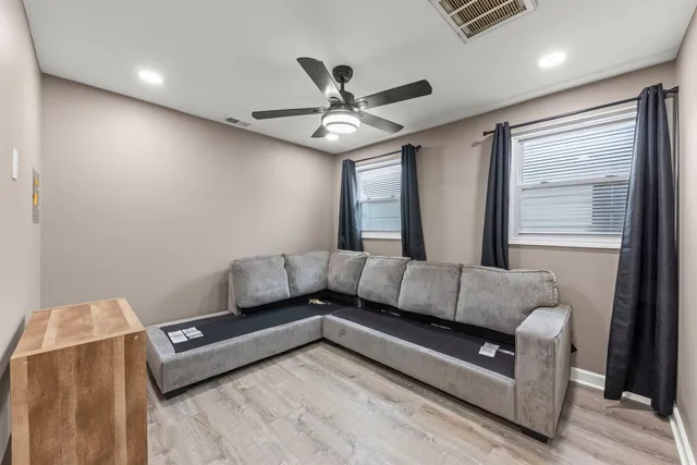 a living room with furniture and a chandelier