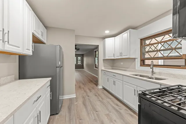 a kitchen with a refrigerator stove and sink