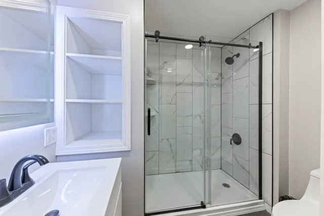 a bathroom with a shower and toilet