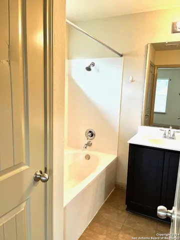 a bathroom with a tub and a sink