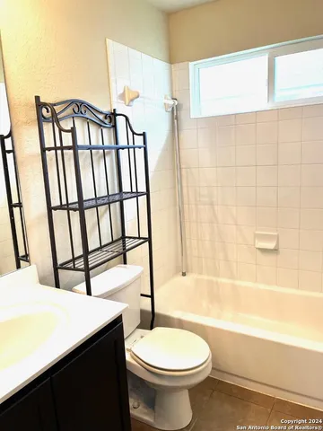 a bathroom with a toilet a sink and bathtub