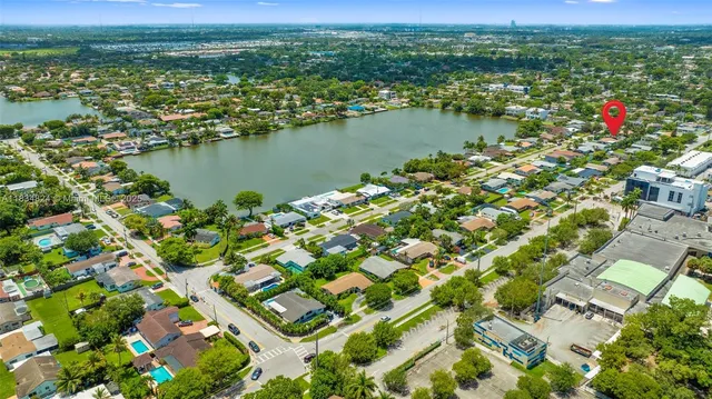 an aerial view of residential houses with outdoor space and river