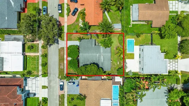an aerial view of a house with a yard and potted plants