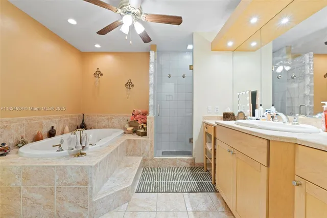 a bathroom with a tub sink and mirror