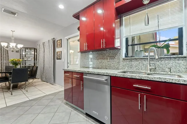 a kitchen with stainless steel appliances granite countertop a sink and cabinets
