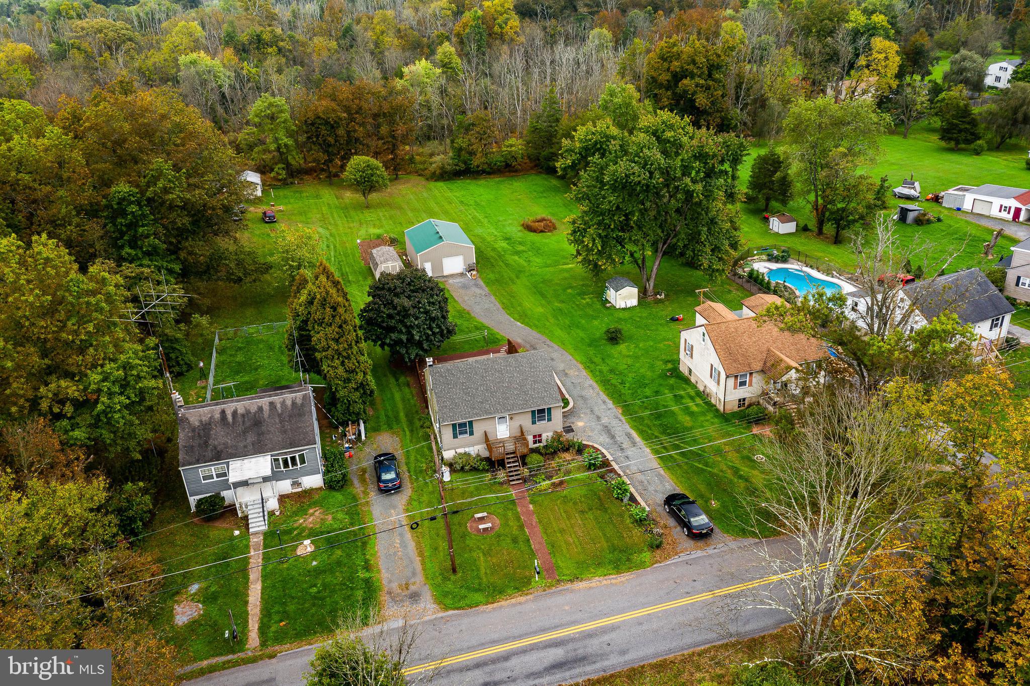 an aerial view of a house with garden space and street view