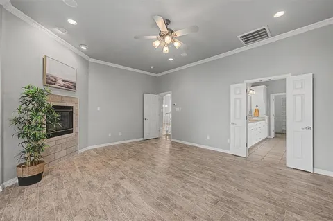 a view of an empty room with a window and a kitchen