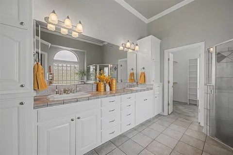 a bathroom with a double vanity sink and a mirror