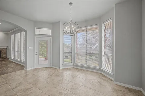 a view of an empty room with glass door