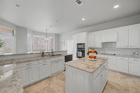 a kitchen with a sink stove and cabinets