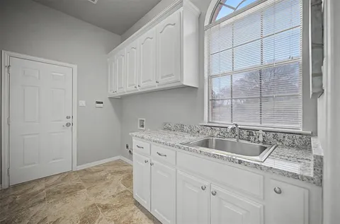 a kitchen with a sink and cabinets