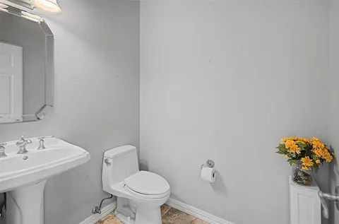 a bathroom with a sink mirror and toilet