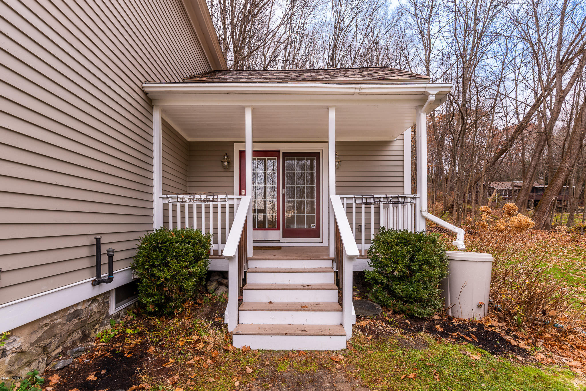 148 Cross Road Richmond, MA 01254 - Photo 4 of 26 a view of a house with large windows and flower plants