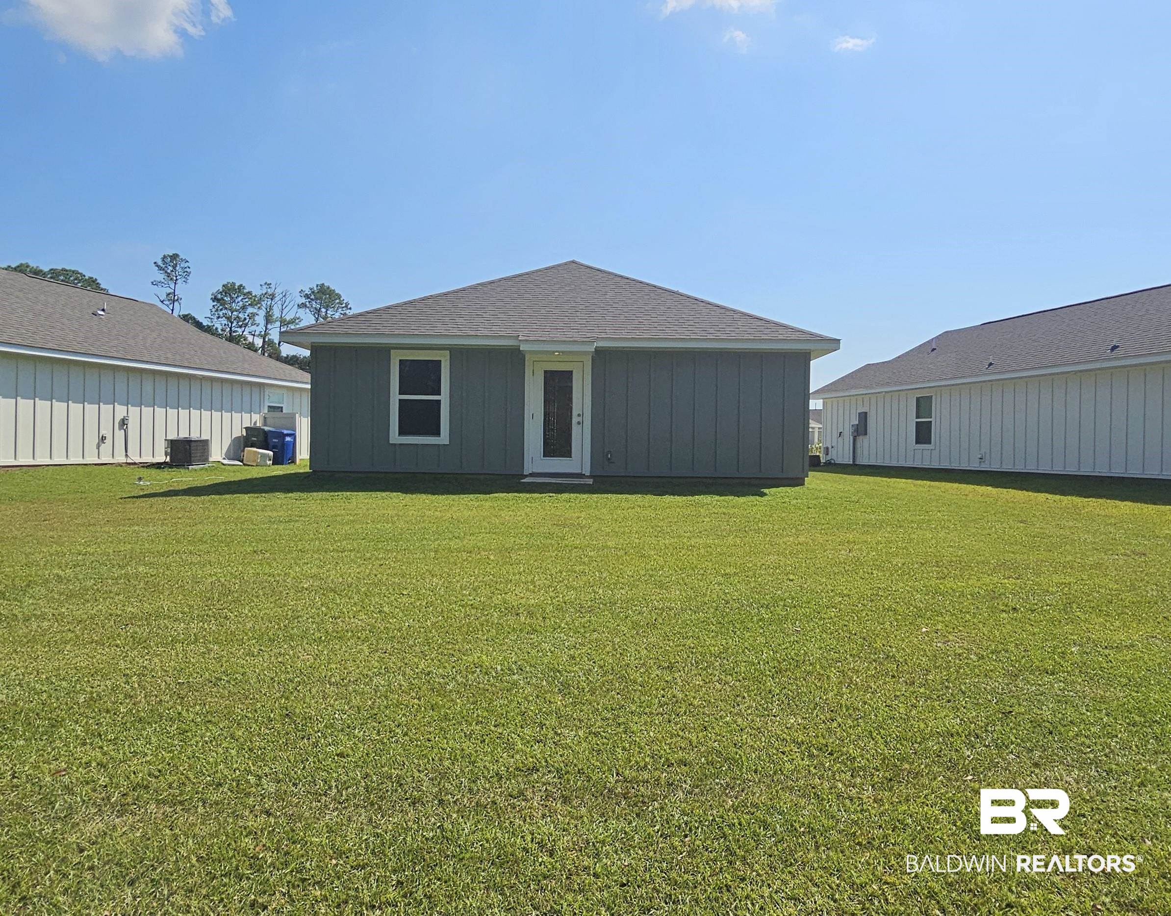 1117 Sweet Laurel Street Foley, AL 36535 - Photo 2 of 5 Back of property featuring a yard, cooling unit, and french doors