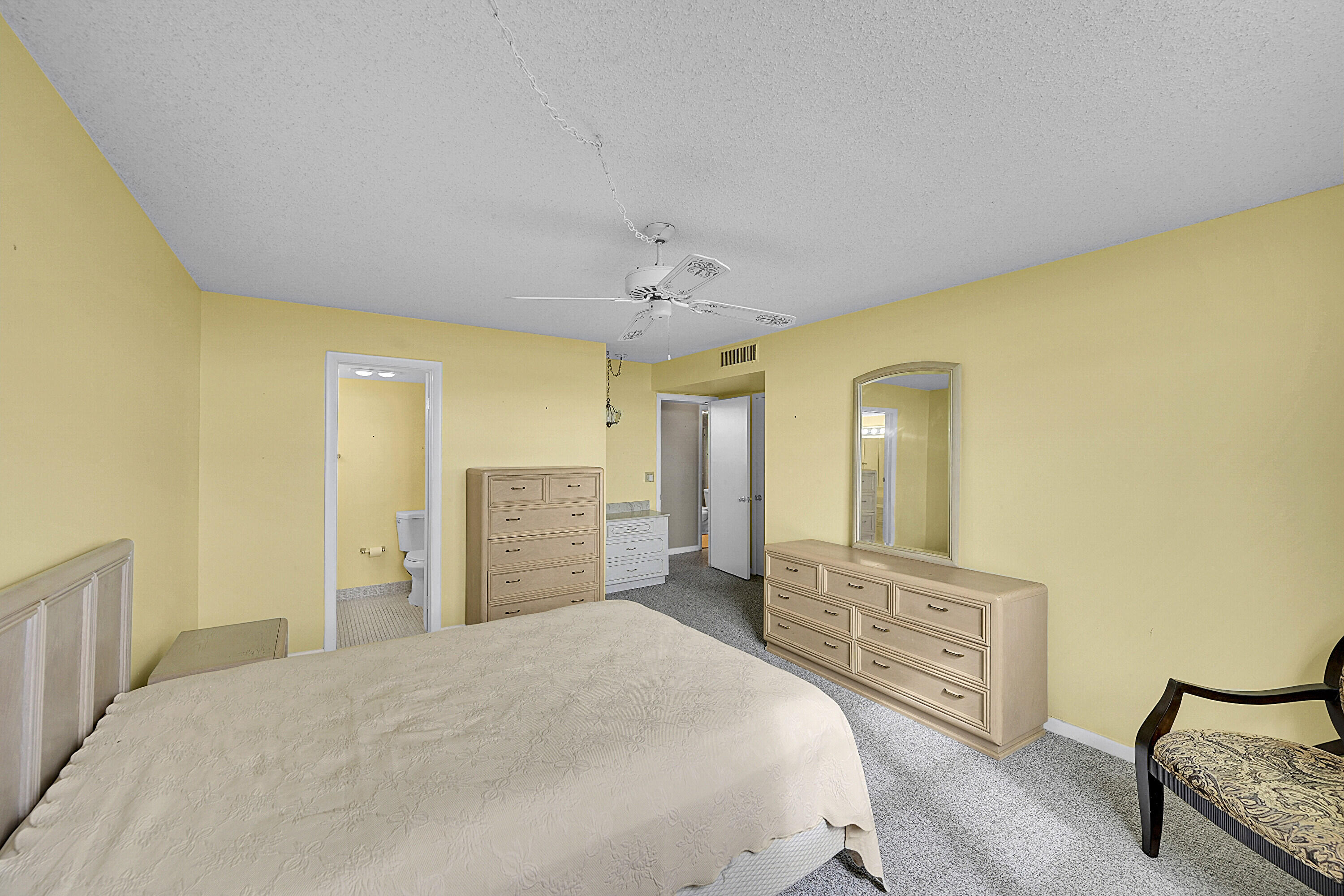 5500 Northwest 2nd Avenue, Unit 614 Boca Raton, FL 33487 - Photo 13 of 24 a spacious bedroom with a bed and a dresser in it