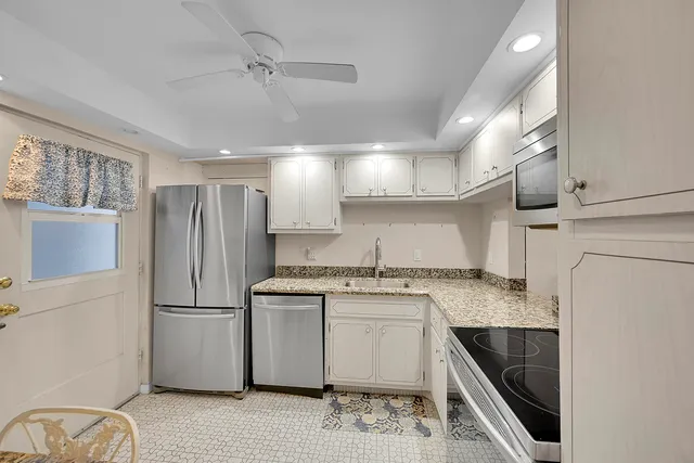 a kitchen with a sink stove and refrigerator