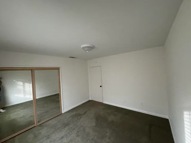 a bathroom with a toilet a sink and a mirror