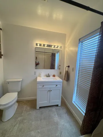 a bed room with a bed and a window