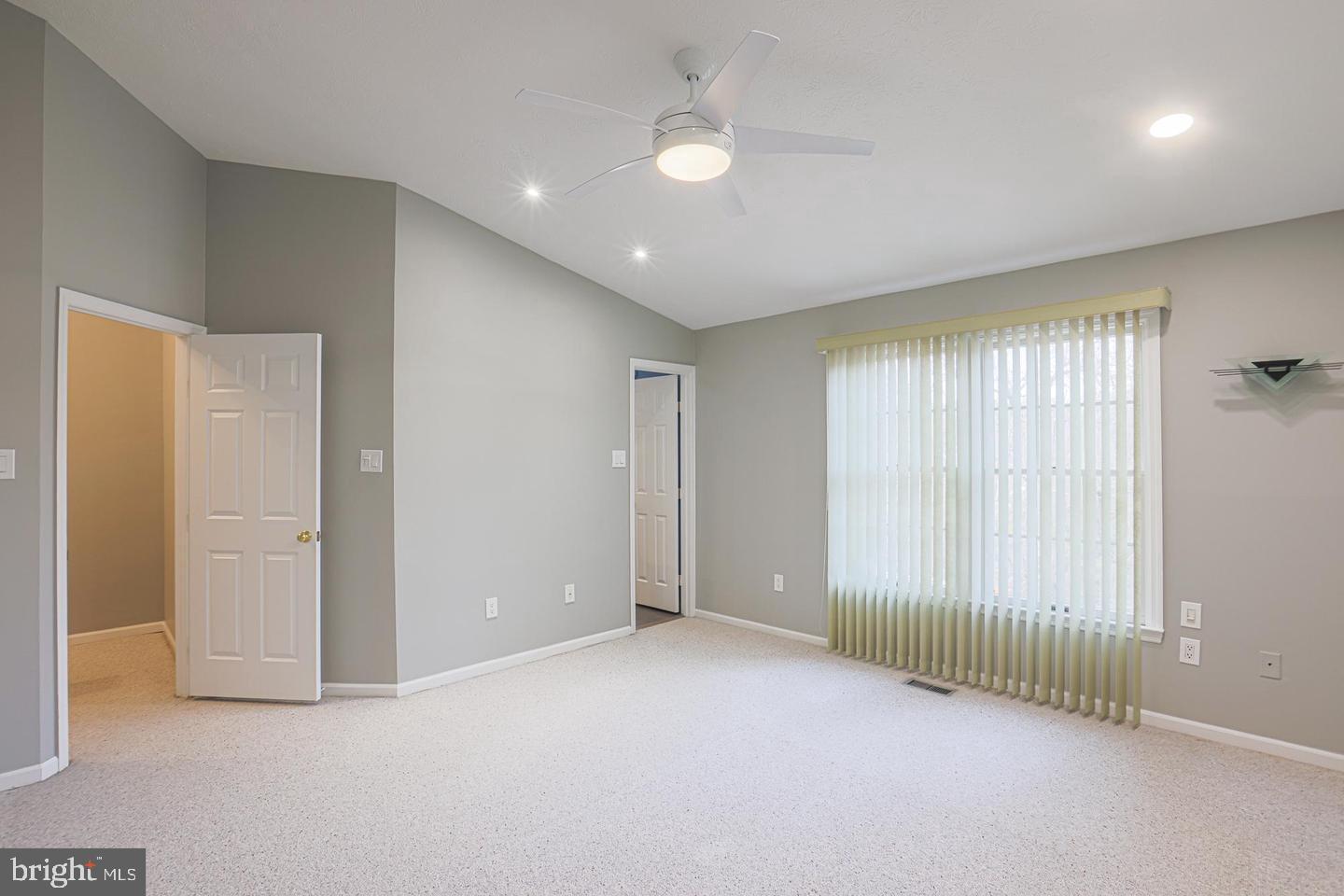 2734 Quarry Heights Way Baltimore, MD 21209 - Photo 11 of 25 an empty room with windows and a ceiling fan