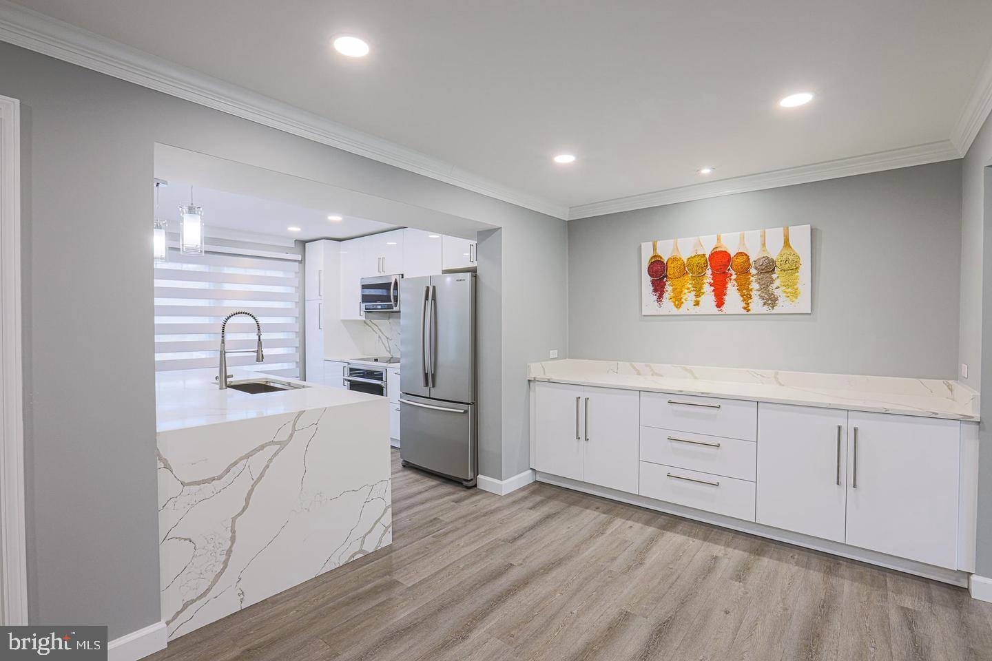 2734 Quarry Heights Way Baltimore, MD 21209 - Photo 5 of 25 a kitchen with white cabinets and stainless steel appliances