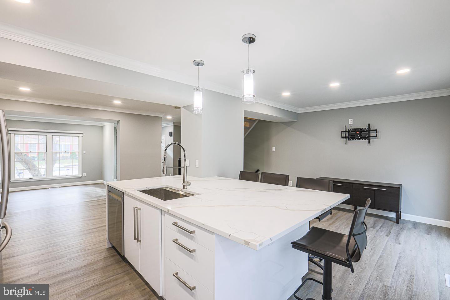 2734 Quarry Heights Way Baltimore, MD 21209 - Photo 6 of 25 a kitchen with a sink a stove a dining table and chairs