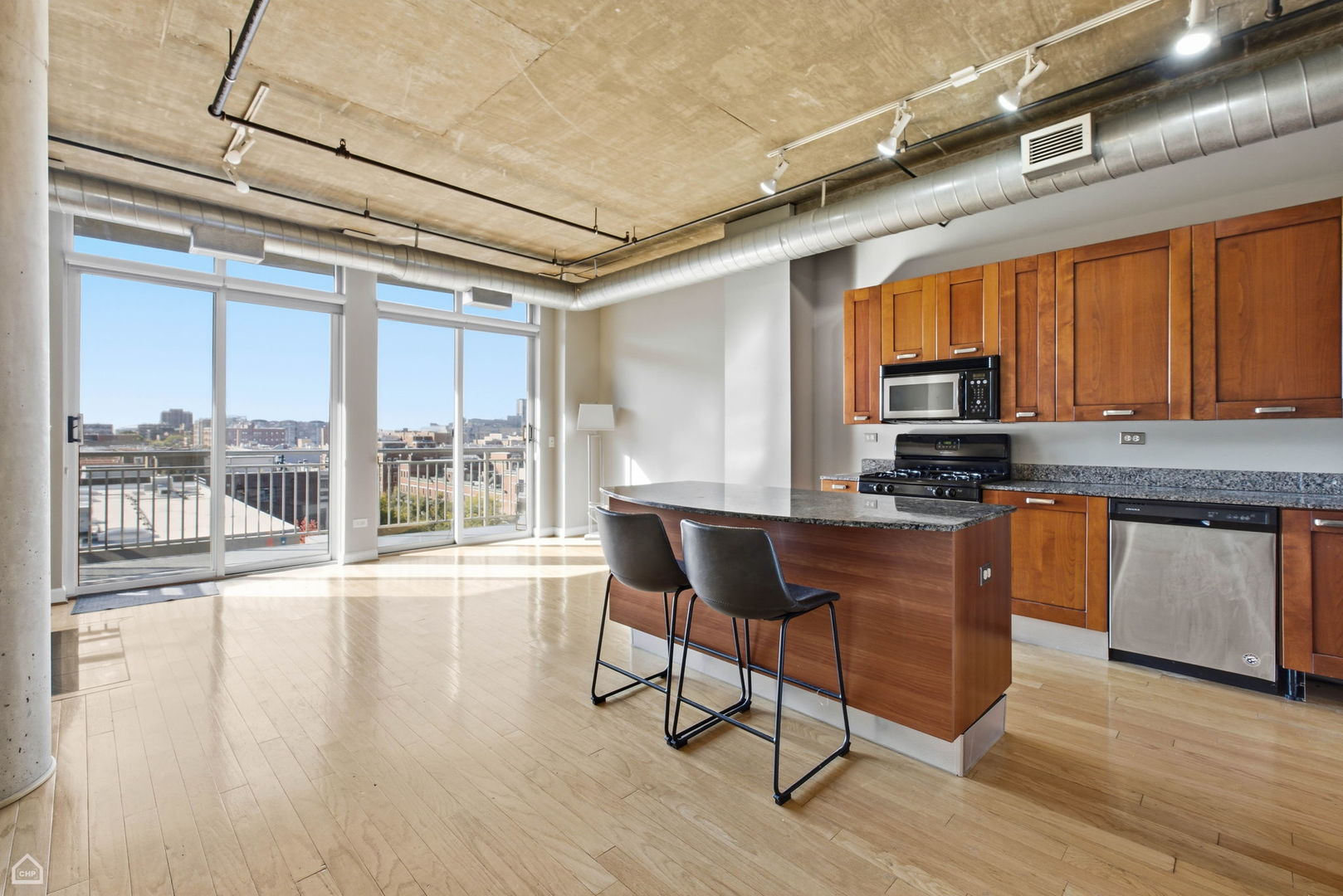 111 South Morgan Street, Unit 701 Chicago, IL 60607 - Photo 4 of 11 a kitchen with stainless steel appliances granite countertop a stove a sink and a microwave