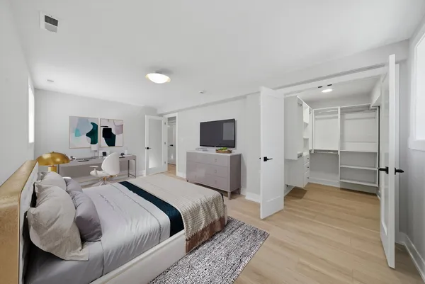 a bedroom with a bed and a flat screen tv