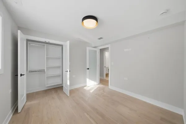 a view of an empty room and closet area