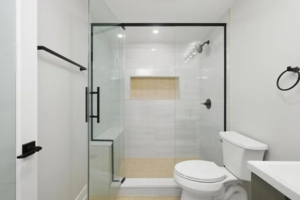 a bathroom with a shower a toilet and a shower