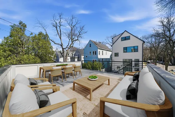 a view of a patio with couches table and chairs and potted plants