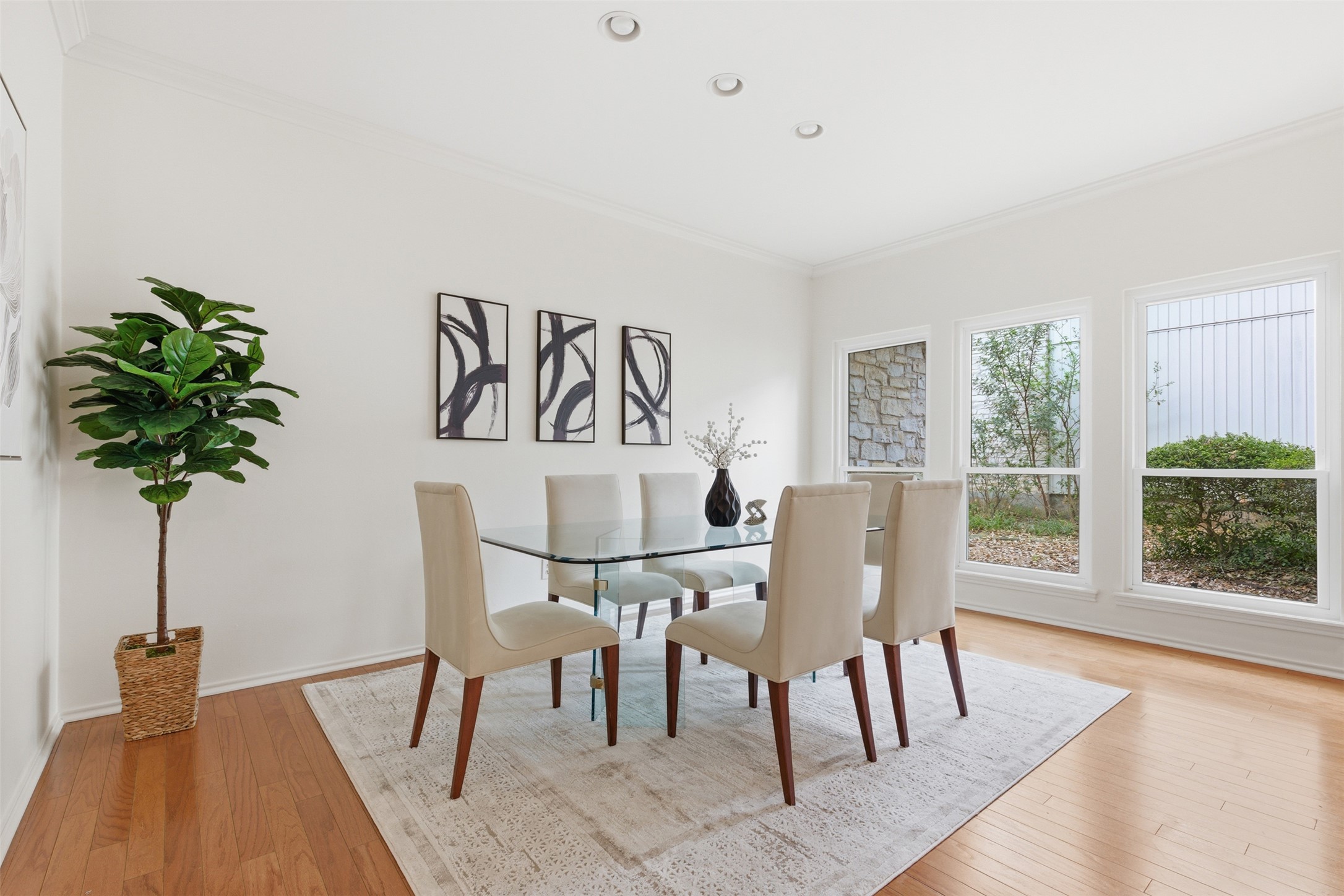 8101 Raintree Place Austin, TX 78759 - Photo 11 of 36 a view of a dining room with furniture window and wooden floor