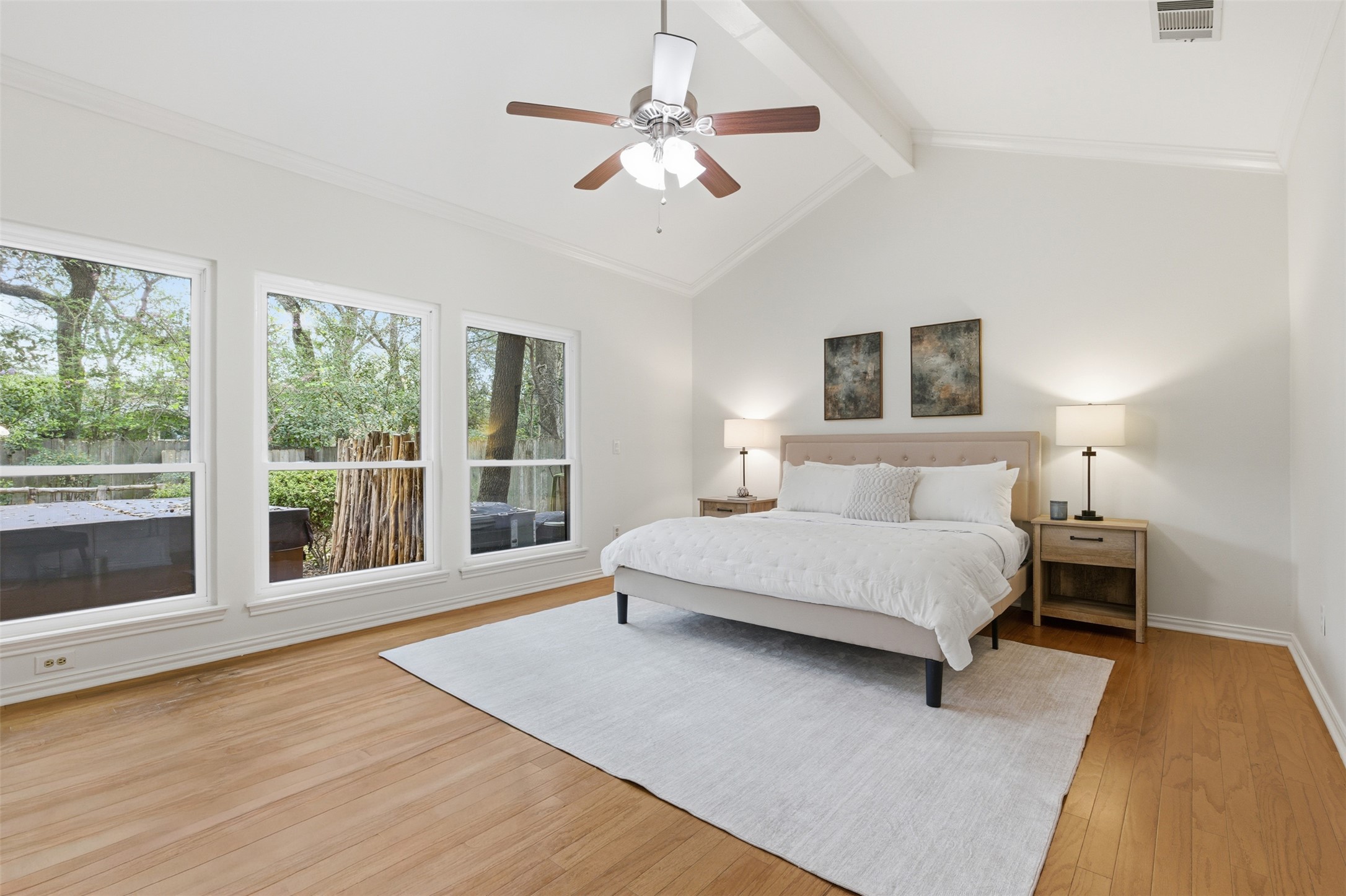 8101 Raintree Place Austin, TX 78759 - Photo 13 of 36 a spacious bedroom with a large bed and a large window