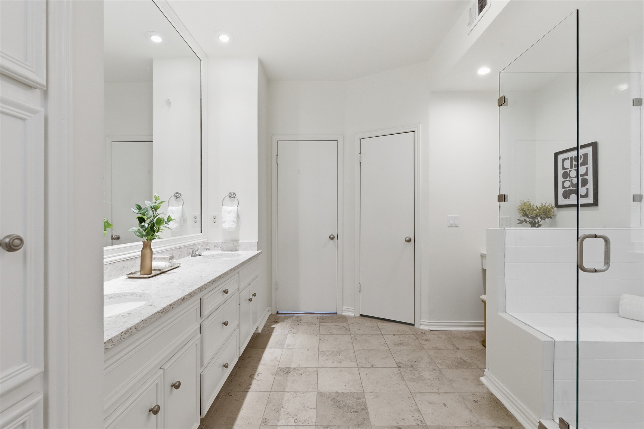 8101 Raintree Place Austin, TX 78759 - Photo 15 of 36 a bathroom with a double vanity sink and shower
