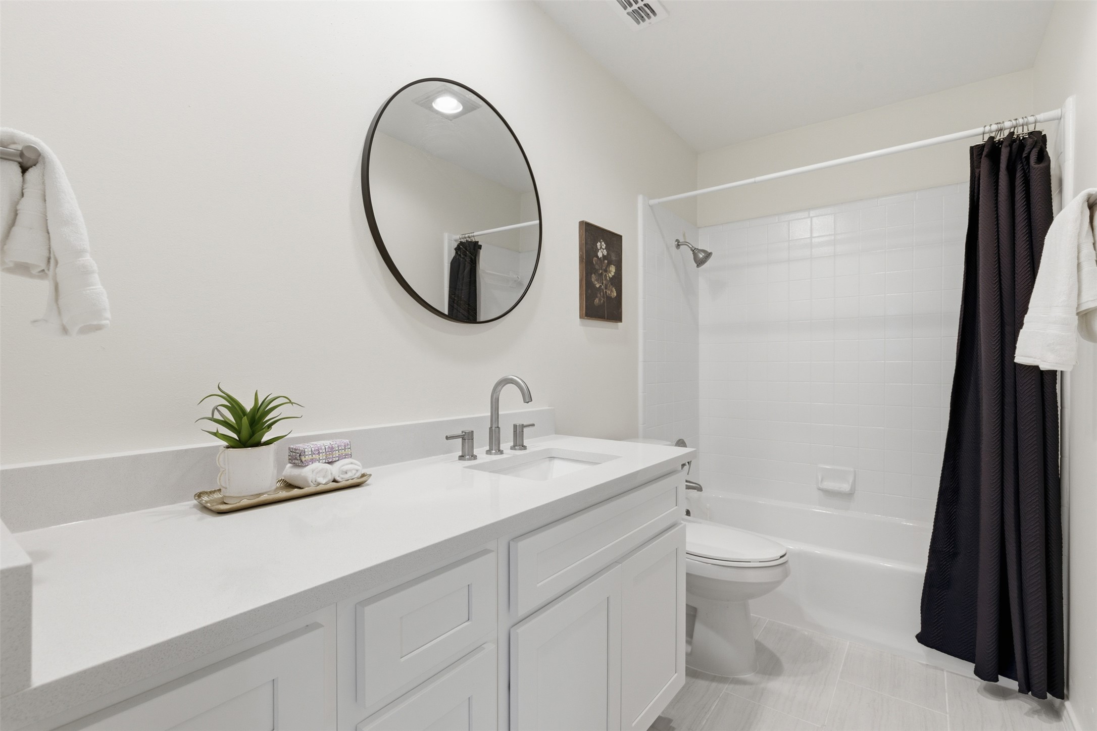 8101 Raintree Place Austin, TX 78759 - Photo 28 of 36 a bathroom with a sink a toilet and a mirror