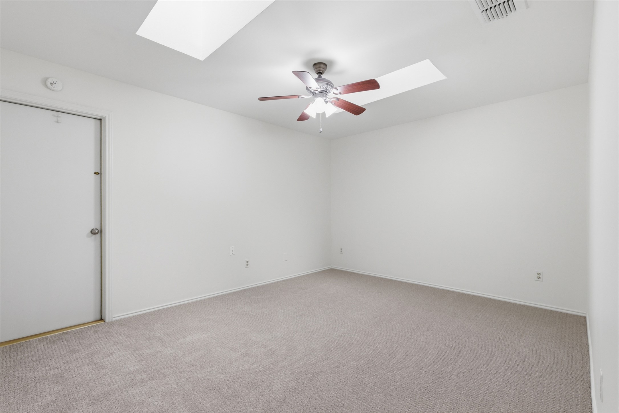 8101 Raintree Place Austin, TX 78759 - Photo 29 of 36 an empty room with a window and a fan