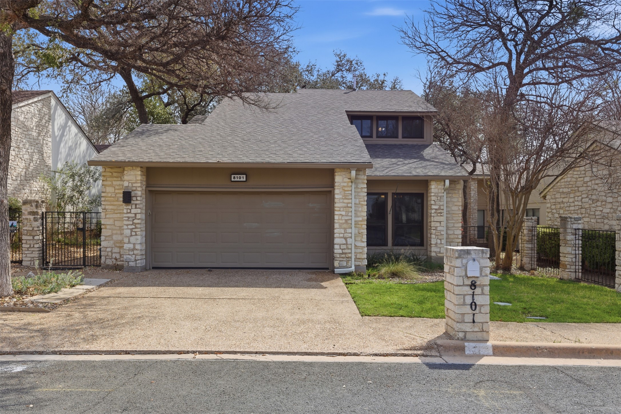8101 Raintree Place Austin, TX 78759 - Photo 3 of 36 a front view of a house with a garden and plants