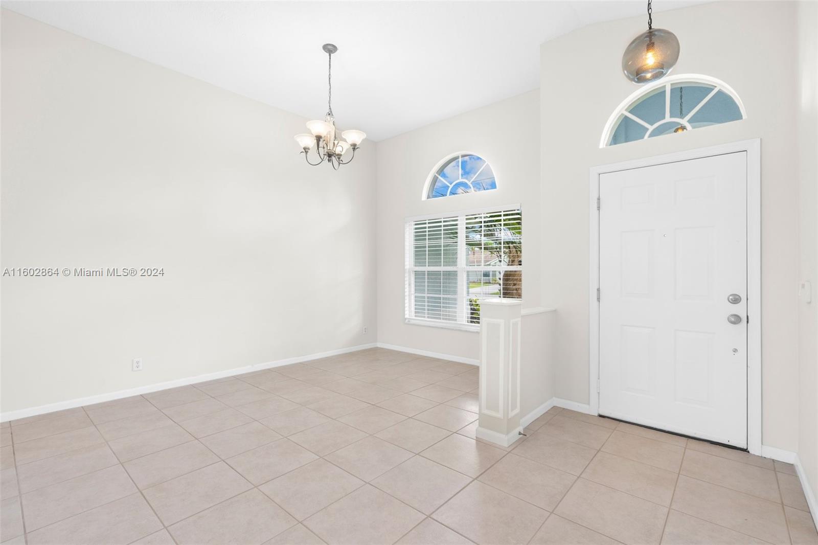 6054 Foster Street Jupiter, FL 33458 - Photo 15 of 50 an empty room with windows and ceiling fan