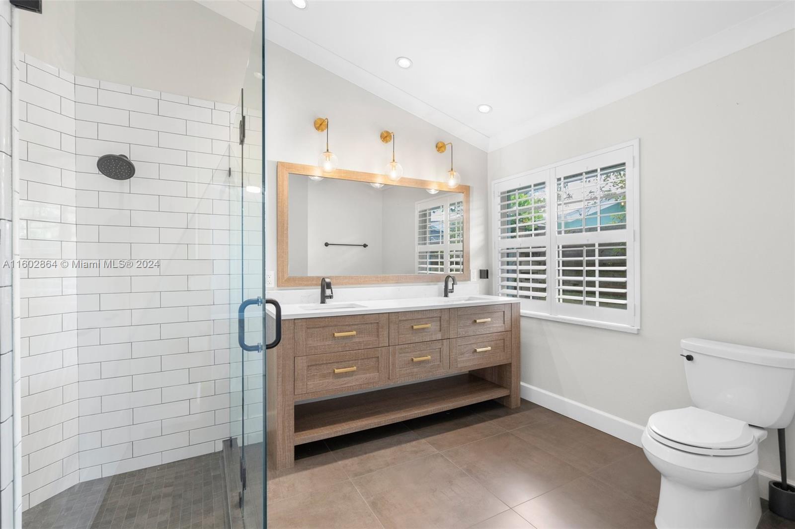 6054 Foster Street Jupiter, FL 33458 - Photo 26 of 50 a bathroom with a bathtub sink and toilet