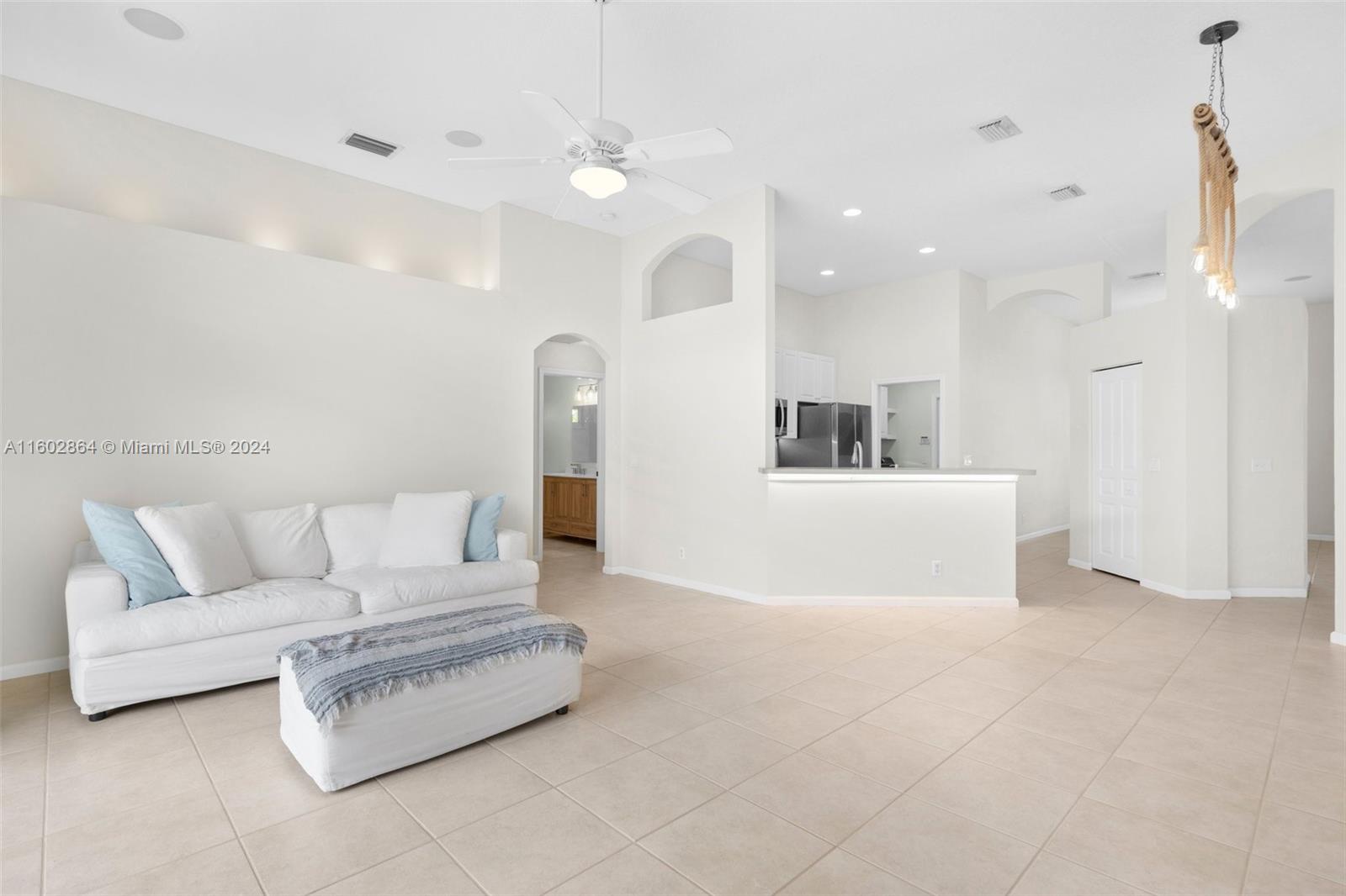 6054 Foster Street Jupiter, FL 33458 - Photo 27 of 50 a living room with furniture and a couch