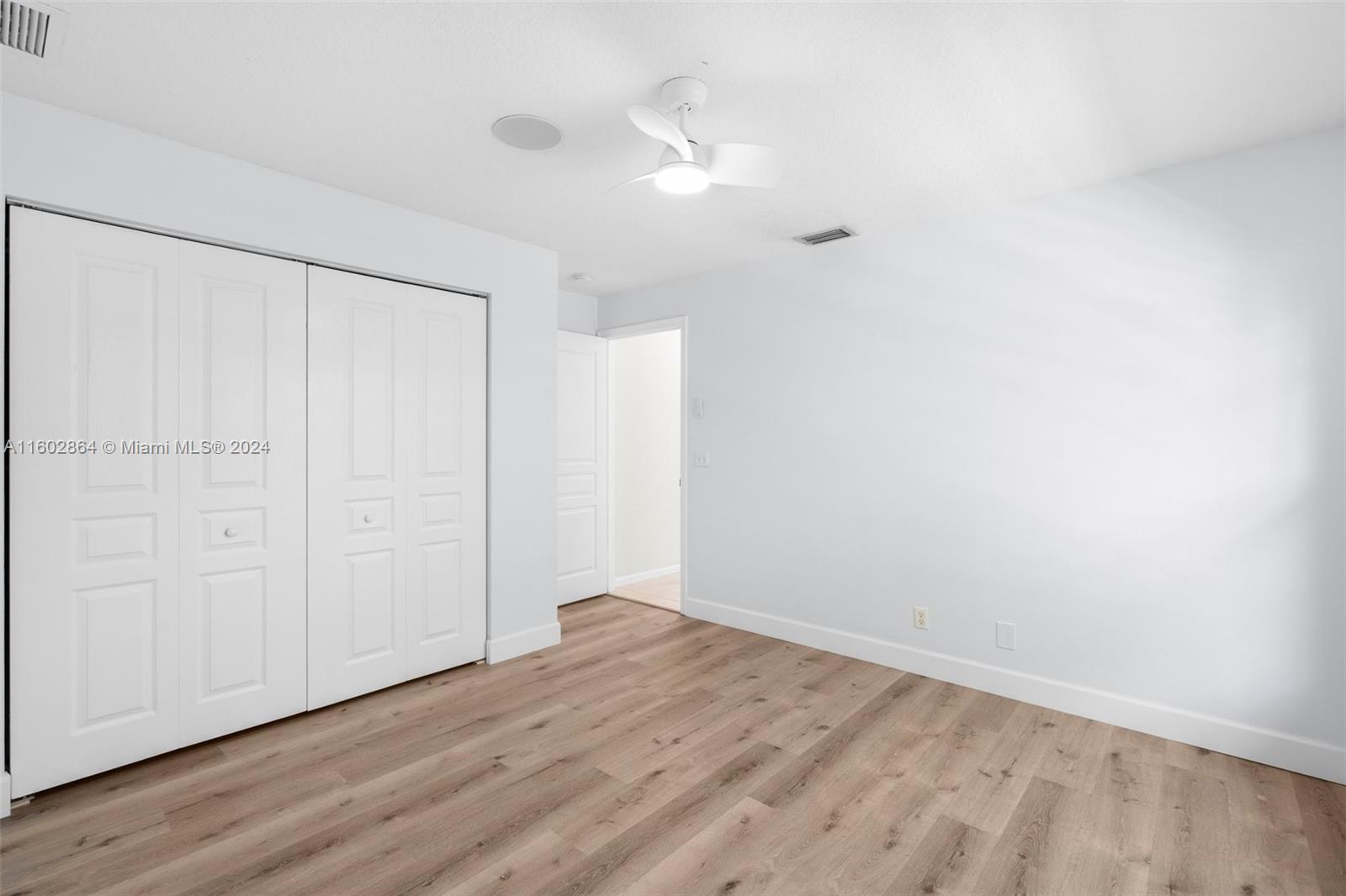 6054 Foster Street Jupiter, FL 33458 - Photo 28 of 50 a view of an empty room with wooden floor