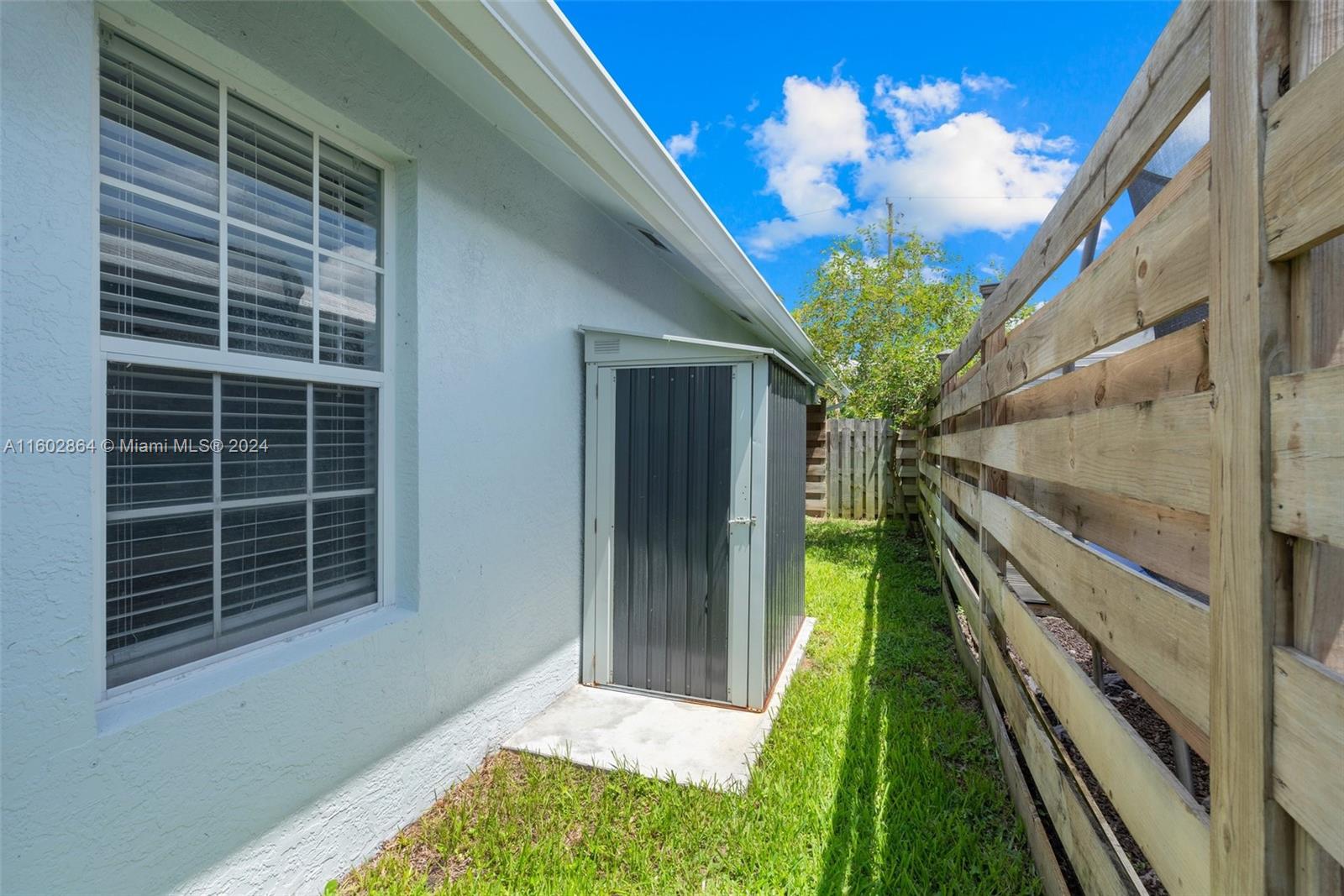 6054 Foster Street Jupiter, FL 33458 - Photo 39 of 50 a porch with a chandelier