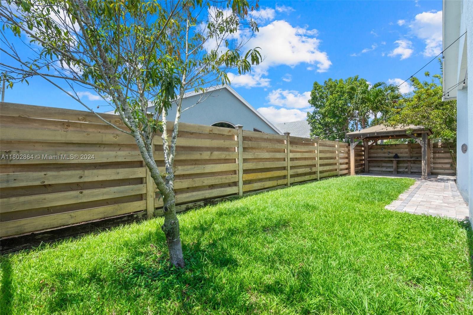 6054 Foster Street Jupiter, FL 33458 - Photo 40 of 50 a house view with a garden space