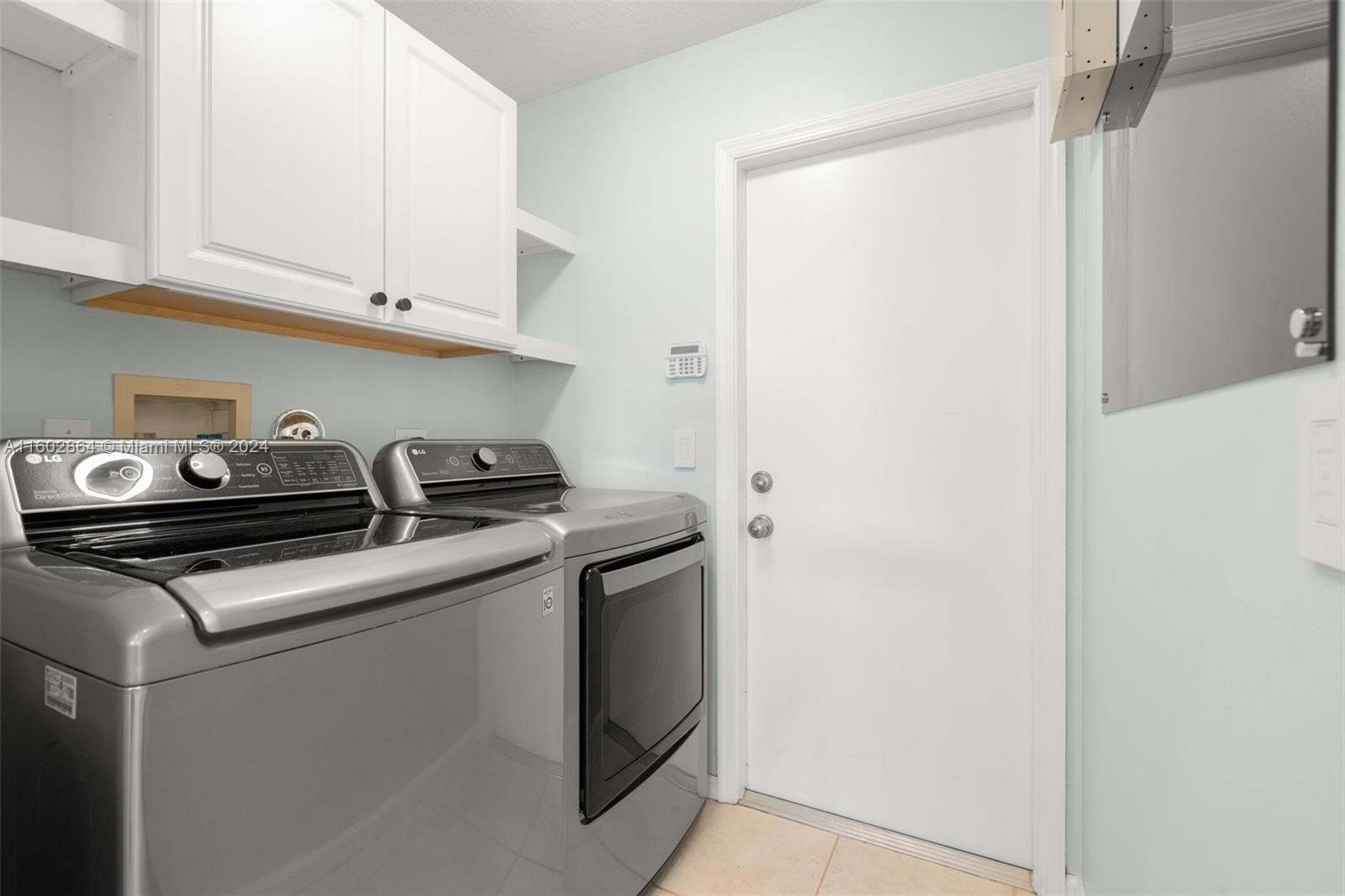 6054 Foster Street Jupiter, FL 33458 - Photo 41 of 50 a kitchen with stainless steel appliances granite countertop white cabinets and a stove