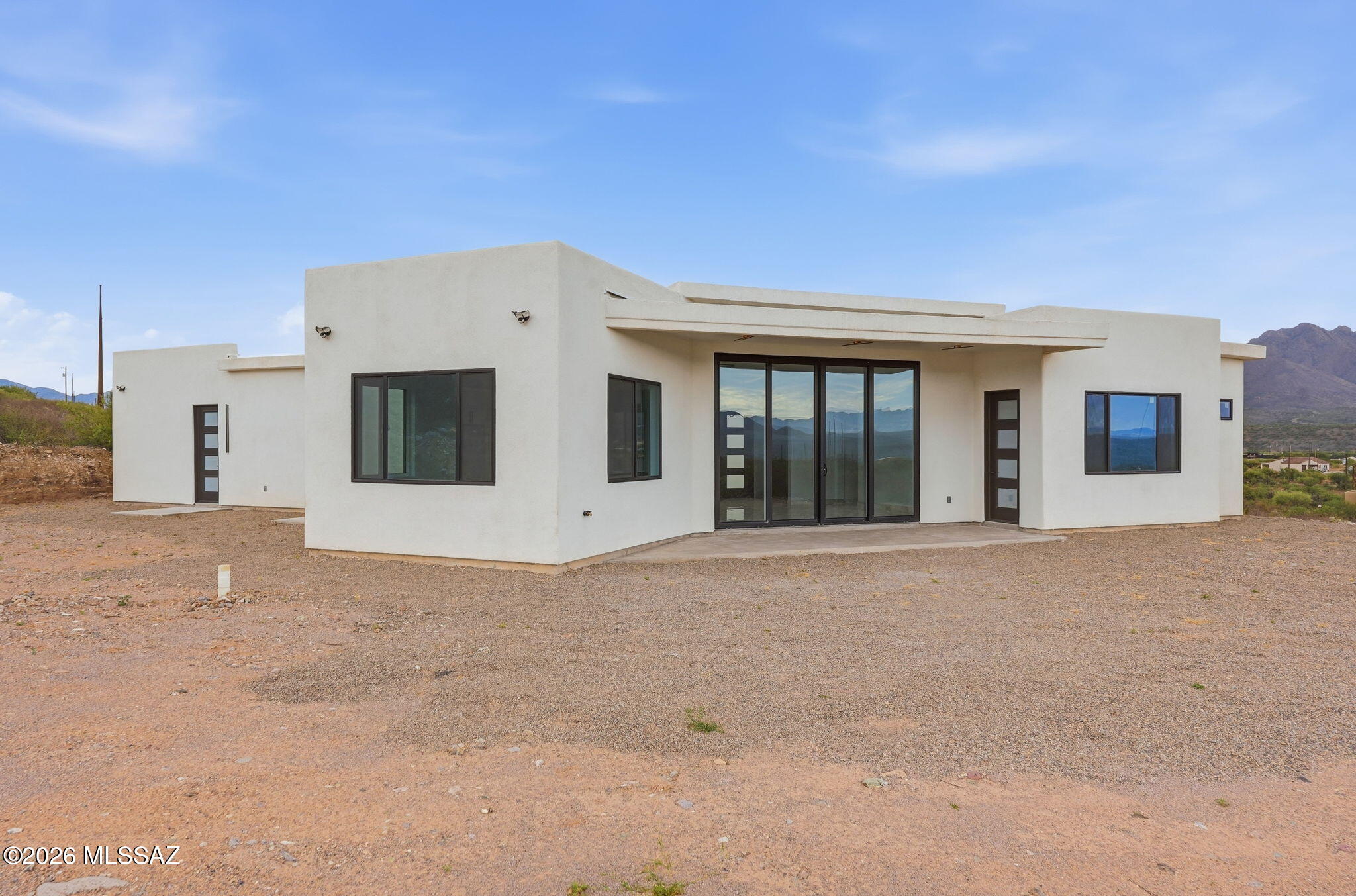1786 Peralta Court Rio Rico, AZ 85648 - Photo 8 of 50 a view of a white house with a large parking space