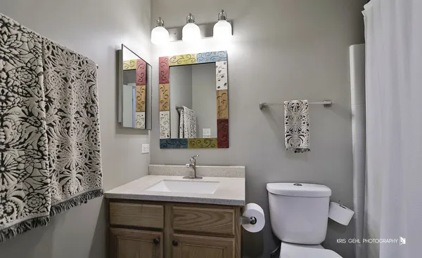 a bathroom with a sink toilet and mirror