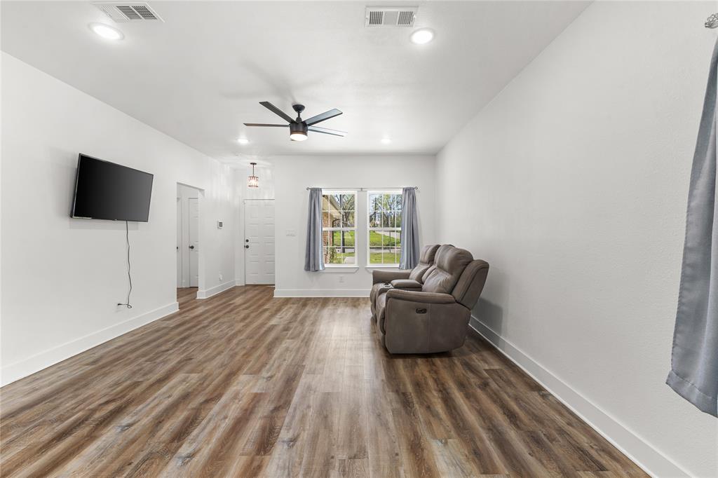 101 Ross Street Sulphur Springs, TX 75482 - Photo 5 of 30 Unfurnished room featuring dark wood-type flooring, ceiling fan, and recessed lighting