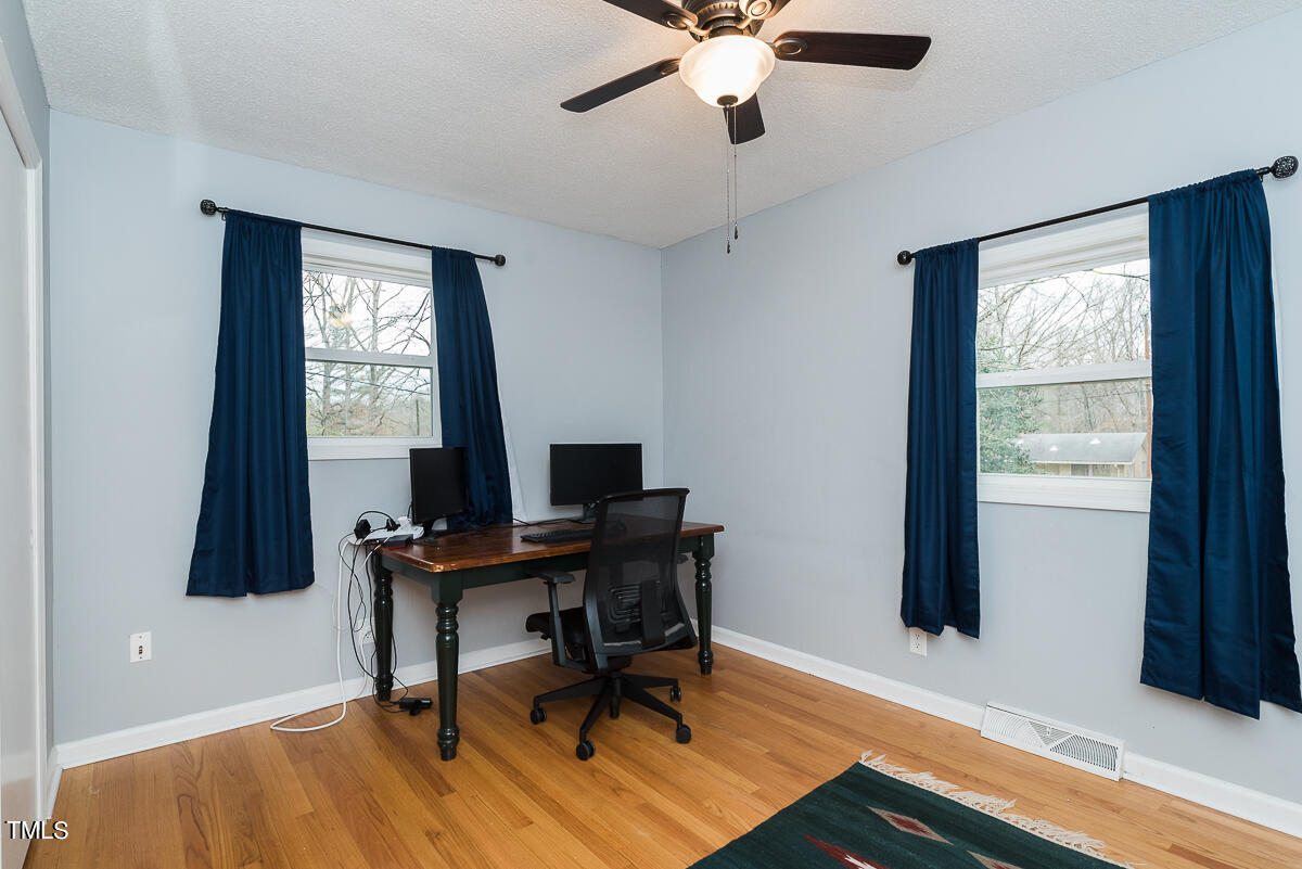 1026 Jerome Road Durham, NC 27713 - Photo 12 of 27 a view of a workspace with furniture and a window