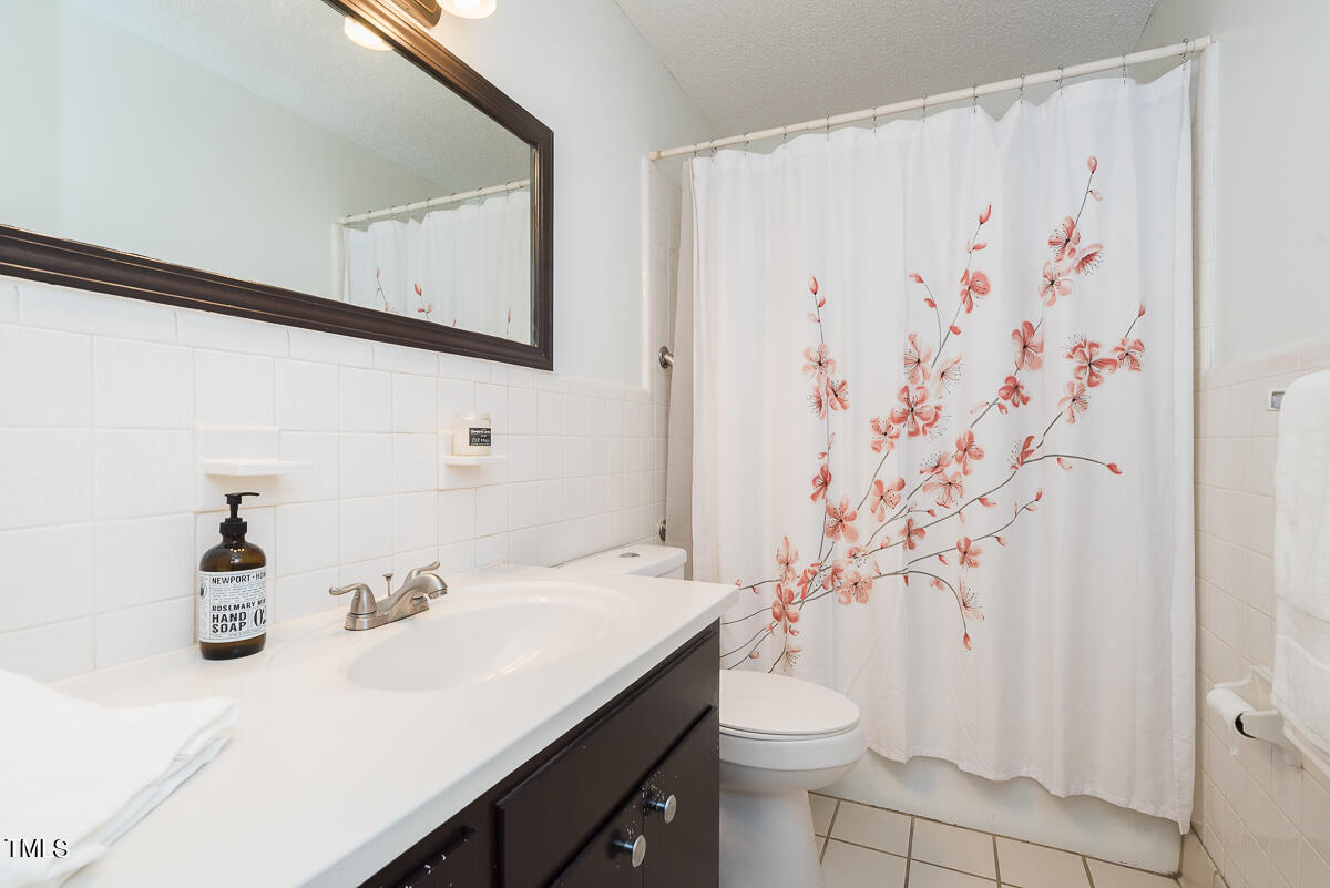1026 Jerome Road Durham, NC 27713 - Photo 15 of 27 a bathroom with a sink and a mirror